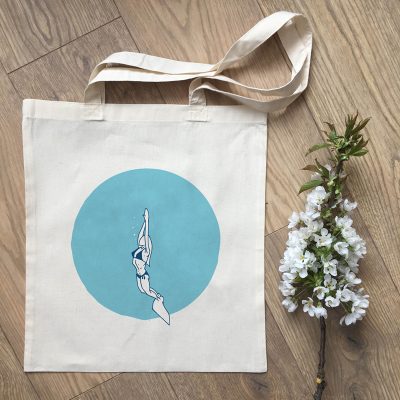 Tote Bag with a girl snorkeling into ocean